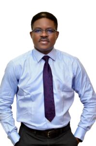 Dr Taiwo Akindipe top half of body, standing straight ahead.